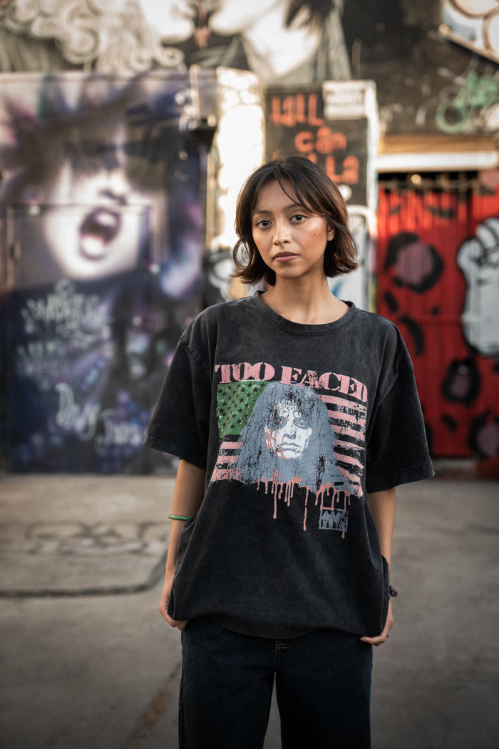 Too Faced campaign photo — model against graffiti mural